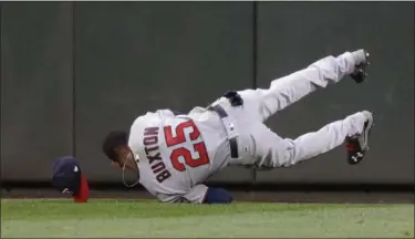  ?? ASSOCIATED PRESS FILE ?? Twins center fielder Byron Buxton lands after making a leaping catch of a line drive hit by Seattle’s Robinson Cano.