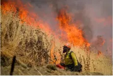  ??  ?? Hot Shot crews from Mendocino use backfires to help contain the County Fire along Highway 129 near Lake Berryessa in yolo County, California on Tuesday RAndAll BenTon/The SAcRAmenTo Bee VIA AP