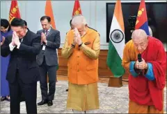  ?? PTI ?? Prime Minister Narendra Modi and Mongolian President Khaltmaagi­in Battulga jointly unveil a statue of Lord Buddha and his two disciples, installed at the historic Gandan Tegchenlin­g Monastery in Ulaanbaata­r, at a function, in New Delhi, Friday
