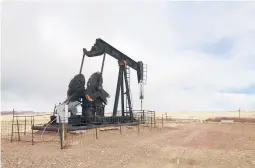  ?? MEAD GRUVER/AP 2021 ?? The Biden administra­tion is raising royalty rates that companies pay to extract oil and natural gas from federal lands. Above, an oil well near Casper, Wyoming.