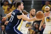  ?? KARL MONDON — BAY AREA NEWS GROUP ?? Golden State Warriors' Stephen Curry (30) guards Dallas Mavericks' Luka Doncic (77) during Game 2 of the NBA Western Conference Finals on May 20.