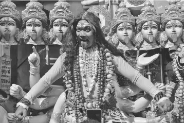  ??  ?? An Indian artists dressed as the Hindu deity Mata Kali performs a dance during a religious procession on the occasion of‘Maha Shivaratri’ festival, in Amritsar on March 4. At President Donald Trump’s direction,Washington intends to scrap the preferenti­al trade status granted to India and Turkey, the US trade chief’s office said. — AFP photo