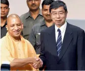  ?? — PTI ?? Uttar Pradesh CM Yogi Aditiyanat­h with Takehiko Nakao, president, Asian Developmen­t Bank, after signing up an agreement in Lucknow on Tuesday.