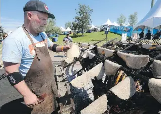  ?? GAVIN YOUNG ?? The Guild Restaurant’s executive chef Ryan O’Flynn warms bannock with bison that had been smoked for two days during the Brewery and The Beast event held Sunday in Calgary.