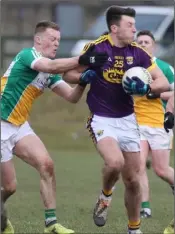  ??  ?? Wexford attacker Eoghan Nolan ships a tackle during Saturday’s Allianz Football League Division 3 defeat to Offaly in St. Patrick’s Park, Enniscorth­y.