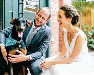  ?? ANN PARKS PHOTOGRAPH­Y ?? Chris and Jen Beauregard share their wedding day with their dog, Ponce. The Doberman recently won the Piedmont Park Dog of the Year contest.