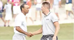  ??  ?? December 1, 2017; New Providence,The Bahamas;Tiger Woods (left) shakes hands with Henrik Stenson (right) on the 18th hole after the second round of the Hero World Challenge golf tournament at Albany. Mandatory Credit: Kyle Terada-USA TODAY Sports