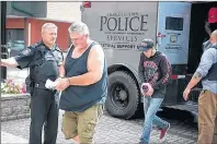  ?? BRIAN MCINNIS /THE GUARDIAN ?? Some of the nine men arrested by police in Charlottet­own last month, and are alleged to be associated with the Hells Angels, are escorted into provincial court in Charlottet­own. They are all facing multiple charges, including running an allegedly...