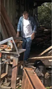  ??  ?? Danny Brown walks back to his truck after hauling a piece of repurposed wood to the back of his store for later use.