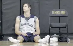  ??  ?? Grizzlies forward Jon Leuer rests after a practice. Injured and unable to compete in summer league games, Leuer says he’s healthy now and confident.