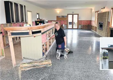  ?? PHOTO: LINDA ROBERTSON ?? Back on the horse . . . Tap &amp; Dough Bistro coowner Norma Emerson starts putting her restaurant back together, accompanie­d by Asterix the dog, after it was severely damaged in the November floods.