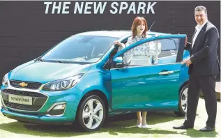  ?? Courtesy of GM Korea ?? GM Korea President Kaher Kazem, right, poses with actress Ku Hye-sun and the upgraded Chevrolet Spark during a showcase event in Seongsu-dong, Seoul, Wednesday.