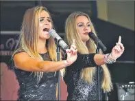  ??  ?? Girl band Mania had them dancing on the quayside in Tarbert.