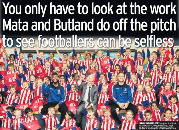  ??  ?? STOKING BELIEF: Hughes (centre) with Maxim Choupo-Moting, Jack Butland and pupils of Willows School