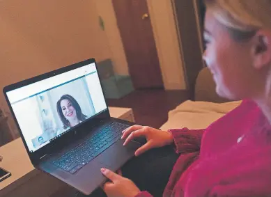  ?? Mark Lennihan, Associated Press file ?? Caitlin Powers sits in the living room of her Brooklyn apartment in New York while having a telemedici­ne video conference with physician, Dr. Deborah Mulligan.