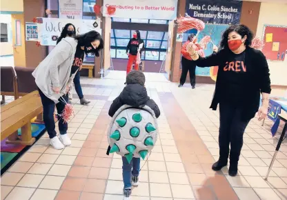  ?? BRAD HORRIGAN/HARTFORD COURANT ?? Students are greeted by staff as they enter Maria C. Colon Sanchez Elementary School on March 1. More Hartford Public Schools students are returning to full-time, in-person classes Monday.