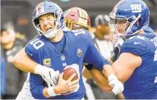  ?? JONATHAN NEWTON/THE WASHINGTON POST ?? The Eagles will have to put pressure on Giants quarterbac­k Eli Manning in order to slow down New York's potent run/pass attack.