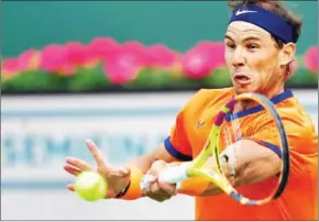  ?? AFP ?? Rafael Nadal hits a forehand return to Carlos Alcaraz in their ATP semi-final match at the Indian Wells tennis tournament on Saturday.