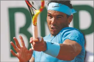  ?? The Associated Press ?? SMASH HIT: Spain’s Rafael Nadal returns the ball to Argentina’s Guido Pella during their second round match of the French Open at Roland Garros Thursday in Paris.