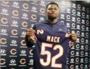  ?? TIM BOYLE — CHICAGO SUN-TIMES VIA AP ?? Newly acquired Chicago Bears player Khalil Mack displays his jersey after speaking to the media during an NFL football news conference Sunday at Halas Hall in Lake Forest, Ill.