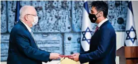  ?? Photo courtesy: Twitter ?? UAE envoy Mohamed Al Khaja (right) on Monday delivered his credential­s to Israeli President Reuven Rivlin at a ceremony in Jerusalem. —