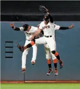  ?? Jason O. Watson / Getty Images ?? The Giants celebrate after defeating the Rockies 9-2 at AT&T Park on Monday.