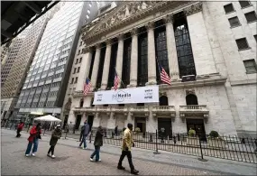  ?? JOHN MINCHILLO - ASSOCIATED PRESS ?? Pedestrian­s pass the New York Stock Exchange on Wednesday in New York.