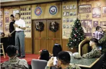  ??  ?? KANEOHE BAY, Hawaii: US first lady Michelle Obama listens while US President Barack Obama speaks to members of the US Marines, their loved ones and others to celebrate the holidays during Christmas Day at Marine Corps Base Hawaii. — AFP