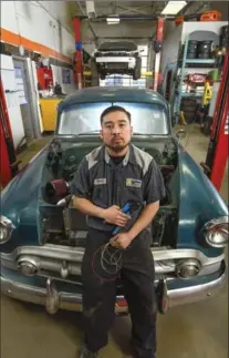  ?? GARY YOKOYAMA, THE HAMILTON SPECTATOR ?? Nam Ngo, 32, is the co-owner and operator of NV Auto, where he’s shown in front of a 1953 Chevy undergoing restoratio­n work.