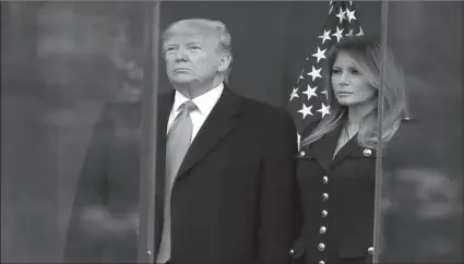  ?? -AP ?? President Trump and first lady Melania Trump pause during a moment of silence at a Veterans Day Parade and Wreath Laying ceremony in Manhattan.