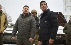  ?? Associated Press ?? Ukrainian President Volodymyr Zelenskyy, left, and British Prime Minister Rishi Sunak observe destroyed Russian military vehicles in downtown Kyiv, Ukraine, on Saturday.