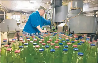  ?? PETER MARTEKA/HARTFORD COURANT ?? Avery’s Beverages general manager Rob Metz fills bottles of Shutdown Swill, a new flavored soda to commemorat­e the recent government shutdown. About 5,000 have been produced so far during a “traditiona­lly slow time of year” for the company, he said.