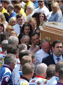  ??  ?? Above: the remains of Bobby Messett (right) are carried to the cemetery after his funeral Mass at St Mochonog’s Church, Kilmacanog­ue, Co Wicklow, yesterday. Below: family members walk behind the coffin as it is carried from the church. Below right:...