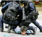  ?? Photo: Winson Wong ?? Police subdue a protester in Wan Chai during a march against the national anthem bill.