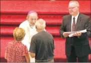  ?? Photo by Becky Polaski ?? Bishop Lawrence T. Persico presents James and Katherine Cheatle with a scroll in honor of their 50th wedding anniversar­y during a Milestone Anniversar­y Celebratio­n Mass held at St. Mary’s Church in St. Marys on Sunday afternoon.