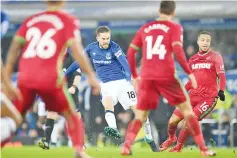  ??  ?? Everton’s Icelandic midfielder Gylfi Sigurdsson takes a shot during the English Premier League football match between Everton and Swansea City at Goodison Park in Liverpool, north west England on December 18, 2017. GOOD AFP photo