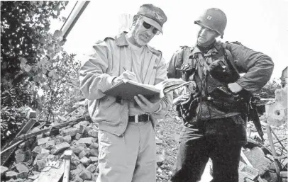  ?? AF ARCHIVE/ALAMY STOCK PHOTO ?? Steven Spielberg works with star Tom Hanks on the set of 1998’s epic Saving Private Ryan.