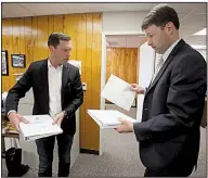  ?? Arkansas Democrat-Gazette/THOMAS METTHE ?? Quapaw Nation attorneys Nate Steel (left) and Alex Gray give a final look to the tribe’s applicatio­n for a casino license Wednesday at the Arkansas Racing Commission offices in Little Rock.