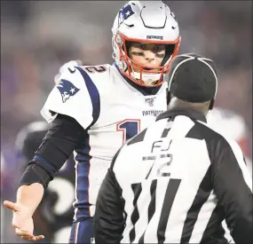  ?? Nick Wass / Associated Press ?? New England Patriots quarterbac­k Tom Brady, left, talks with field judge Michael Banks during a game against the Baltimore Ravens on Sunday in Baltimore. The NFL’s 100th season has not been worth celebratin­g even if the history of the league is.