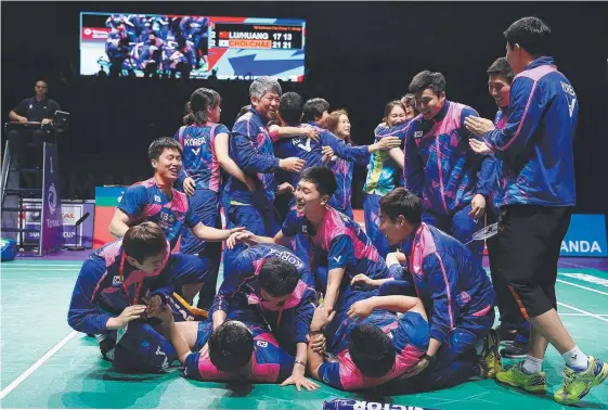  ??  ?? Korea players and staff celebrate after winning Sudirman Cup final with a thrilling upset over China on the Gold Coast. Picture: GETTY IMAGES