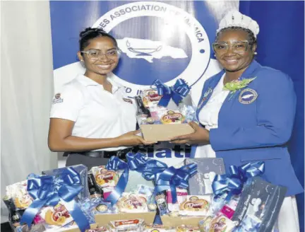  ?? ?? Marketing and business developmen­t manager of Honey Bun Loriann Tater (left) making a presentati­on to Pasty Edwards Henry, president of the Nurses Associatio­n of Jamaica, on Internatio­nal Nurses Day to start the company’s ‘Donuts for Nurses’ initiative for the fourth year.