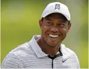  ?? The Associated Press ?? ■ Tiger Woods smiles on the driving range before a practice round for the PGA Championsh­ip Tuesday in Tulsa, Okla.