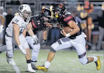  ?? Michael Owen Baker / For The Times ?? OAKS CHRISTIAN running back Zach Charbonnet tries to break free during Friday’s game against Helix.