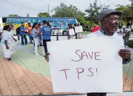  ?? ALEXIA FODERE Miami Herald file, 2018 ?? Michel Bien-Aime wants Haitians in the U.S. to continue to receive Temporary Protected Status. He was participat­ing in a protest at the Little Haiti Cultural Center in Miami.