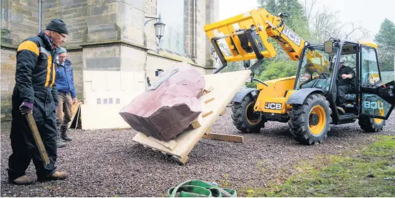  ??  ?? Lift In November 2020 the block of red stone sent from Russia was lowered into position at Errol Parish Church. Pic courtesy of Angus Forbes