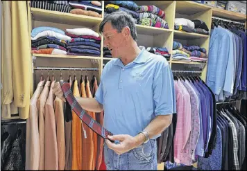  ?? BRANT SANDERLIN / BSANDERLIN@AJC.COM ?? Craig Sager’ closet at his home in Canton housed the flashy array of suits that brightened NBA sidelines during TNT broadcasts.