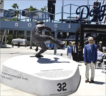  ?? KEITH BIRMINGHAM — STAFF PHOTOGRAPH­ER ?? Dodgers icon Sandy Koufax poses next to his statue, which was unveiled on Saturday in the center-field plaza to honor the Hall of Famer.