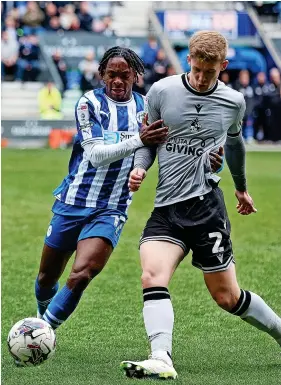  ?? ?? James Connolly battles for the ball with Wigan’s Martial Godo