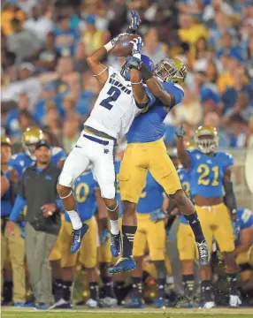  ?? THE ASSOCIATED PRESS ?? Memphis wide receiver Joe Craig, left, makes a catch as UCLA defensive back Fabian Moreau goes up for the ball with him during the first half of an NCAA college football game, Saturday, Sept. 6, 2014, in Pasadena, Calif.