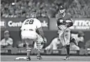  ?? AP Photo/Jeff Roberson ?? n St. Louis Cardinals’ Tommy Pham (28) is out at second as Colorado Rockies shortstop Trevor Story turns a double play during the fifth inning Monday in St. Louis. Cardinals’ Paul DeJong was out at first.